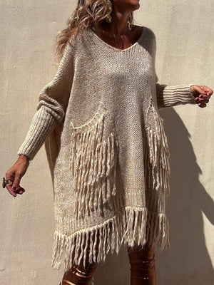 Camel knit poncho sweater with fringe pockets and hem, V-neck, long sleeves.