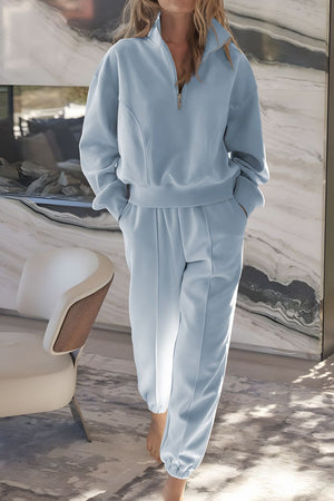 Light blue quarter-zip sweatshirt and jogger set with a relaxed fit and cuffed ankles.