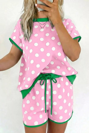 Polka dot pajama set in blush pink polyester with contrast green trim and drawstring shorts.