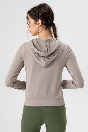 Tan activewear hoodie with long sleeves and a performance fit, shown from the back.