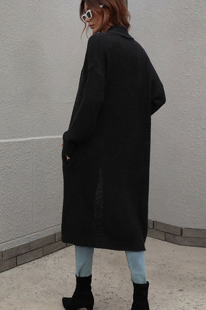 Black textured knit maxi cardigan with pockets and a shawl collar, acrylic material.