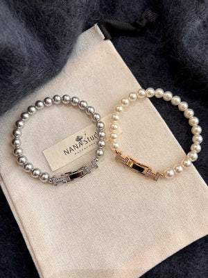 Elegant pearl bracelets in silver and gold with zircon-accented buckles.