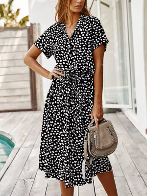 Chic animal print midi dress with tied waist, button-down neckline, and short sleeves.