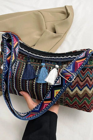 Geometric embroidered shoulder bag with colorful chevron pattern and tassels.