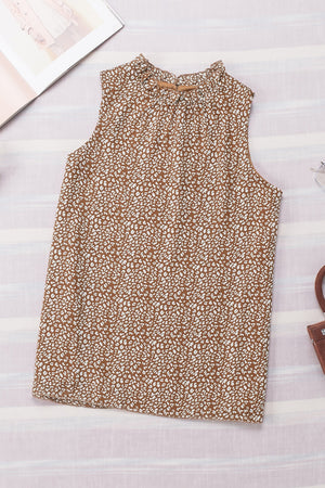 Brown printed sleeveless blouse with ruffled neckline and tie detail.