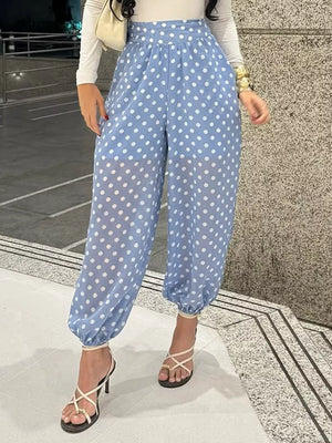 Blue polka dot maternity pants with high waist and cinched ankles.