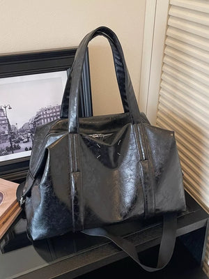 Black distressed vintage leather travel organizer bag with top handles and zipper closure.