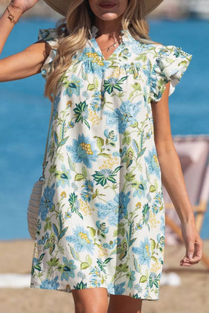 Floral v-neck mini dress with ruffled sleeves in white with blue and green floral print.