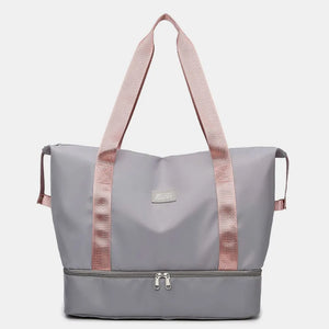 Gray dual-compartment travel tote with pink straps and metallic trim