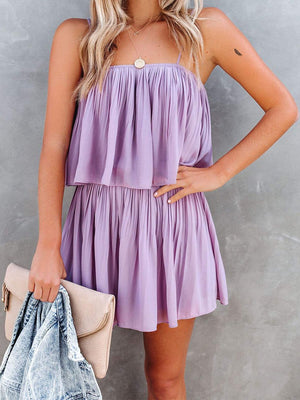 Lilac tiered cami romper with delicate straps and a ruffled hem.