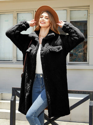 Black quilted teddy bear coat with patch pockets and button front.