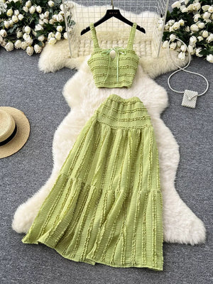 Green ruched crop top and maxi skirt set with tie detail and tiered skirt.