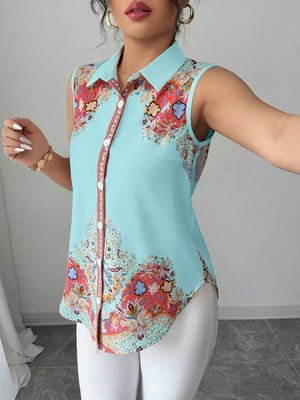 Sleeveless collared shirt in light blue with vibrant paisley print and button front.