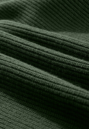Dark green ribbed knit sweater fabric detail