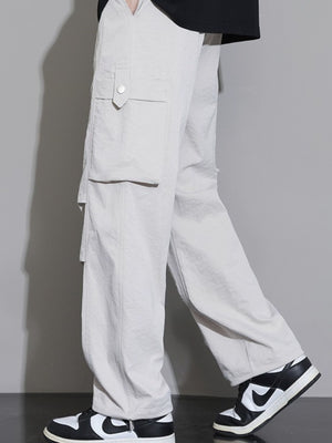 Men's relaxed fit cargo sweatpants in Dust Storm with button-flap pockets.