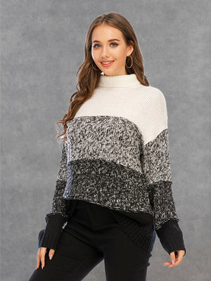 Colorblock turtleneck sweater with defined panels in white, black, and grey marled acrylic knit.
