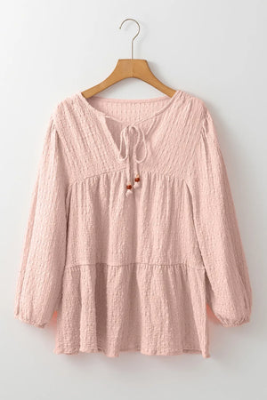 Watermelon pink textured tiered blouse with tie detail and beaded accents.