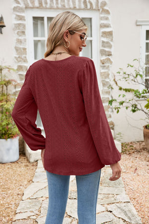 Burgundy eyelet yoke blouse with blouson sleeves and a textured pattern.
