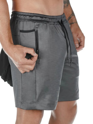Dark gray Tech-Knit utility shorts with zippered pocket detail and drawstring waist.
