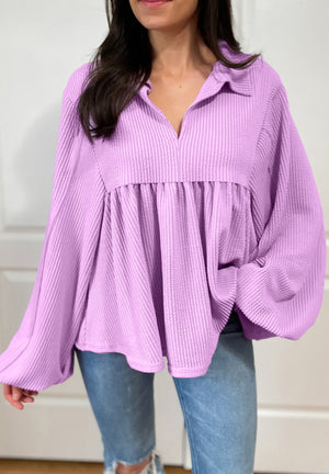 Lilac textured blouse with gathered yoke, collar, and balloon sleeves.
