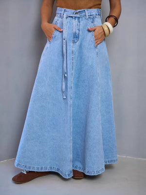 Light blue denim a-line maxi skirt with a tie waist and pockets.