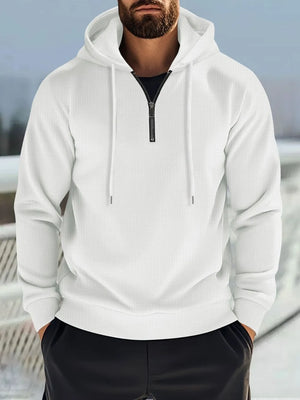 White waffle-knit quarter-zip hooded pullover with black zipper and drawstring.