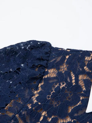 Navy lace midi dress with intricate floral pattern and a white detail.