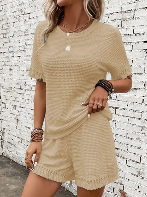 Tan textured knit set with fringe trim on short sleeves and shorts.