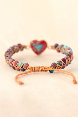 Multicolor beaded bracelet with a red and turquoise heart stone and macrame cord.