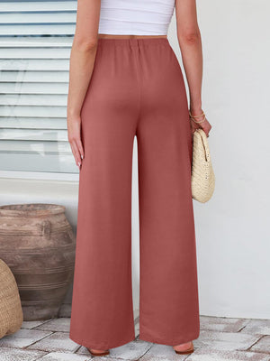 Pleated palazzo trousers in burnt coral with pockets and a wide leg.