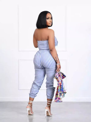 Strapless blue striped romper with pockets, cinched ankles, and white lace-up heels.