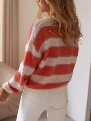 Vibrant striped knit sweater in burnt coral and white with a relaxed fit and crew neck.