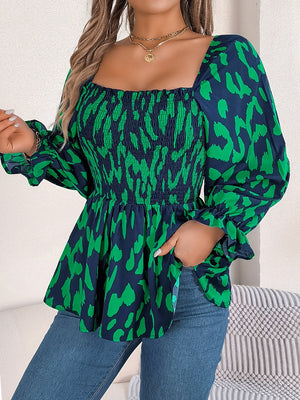 Smocked bodice square neck blouse in dark green and navy animal print with puff sleeves.