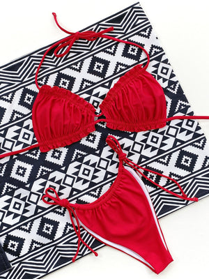 Red ruffle tie bikini set with white trim and string ties.