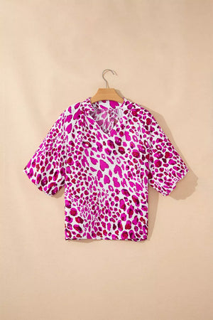 Vibrant leopard print V-neck blouse with short sleeves and a relaxed fit.