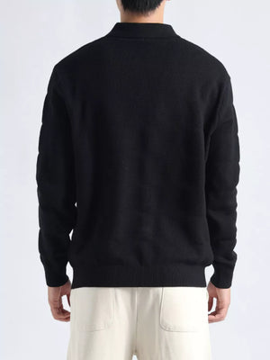 Men's black knit polo top with textured fabric and button accents.