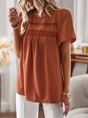 Textured puff sleeve yoke top in terracotta with crochet trim and short sleeves.