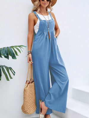 Light blue wide-leg romper with adjustable straps, pockets, and button details.