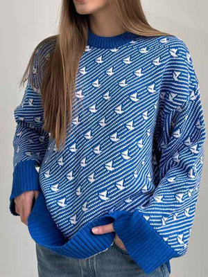 Royal blue knit sweater with white sailboat pattern, crew neck, long sleeves, ribbed cuffs and hem.