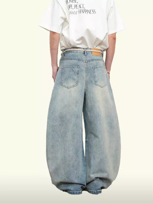 Belted wide leg jeans in light blue denim with balloon silhouette.