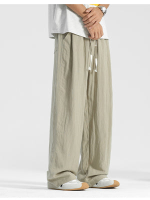 Men's relaxed fit beige sweatpants with drawstring waist and pockets.
