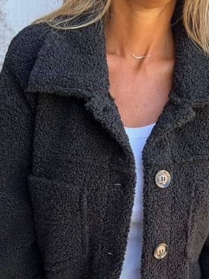 Textured sherpa utility jacket in black with button front and chest pockets.