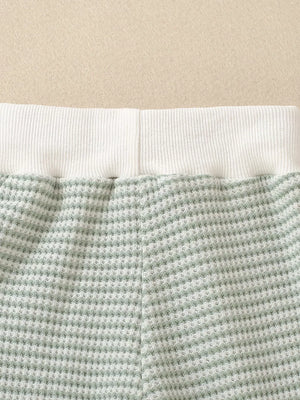 Light green striped baby set with waffle knit fabric and white ribbed waistband.