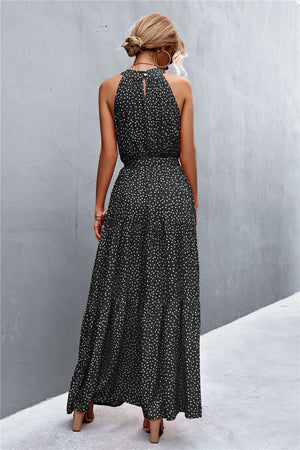 Black polka dot halter neck maxi dress with tiered skirt and back keyhole detail.
