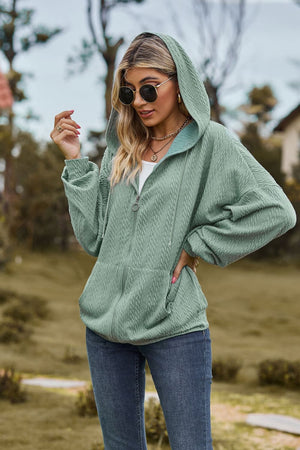 Sage textured cable knit zip-up hoodie with pockets and drawstring hood.