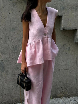 Blush pink sleeveless peplum top and wide-leg pants set in cotton.