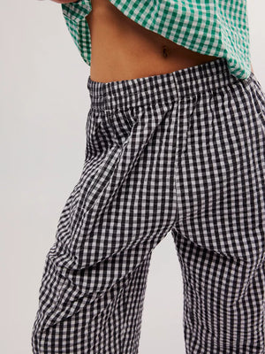 Black gingham check wide-leg pants with pockets and elastic waistband.