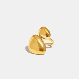 Gold bypass ring with two smooth, sculptural pebble-shaped ends.