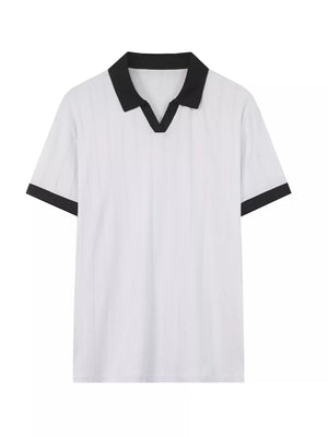 Men's white polo shirt with black contrast collar and sleeve trim, vertical texture detail.