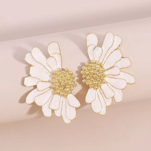 Textured white flower stud earrings with gold centers.